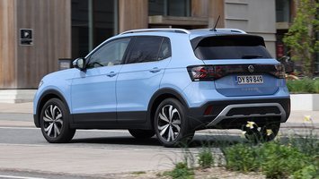 Blå VW T-Cross set bagfra, mens den kører i en by