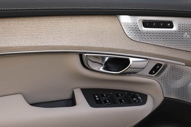 I Volvo XC90 har man fastholdt knapper til hver sin elrude, ligesom spejlene justeres fra knapper i døren på traditionel vis. Materialerne er lækkert sammensat af læder, træ og aluminium.