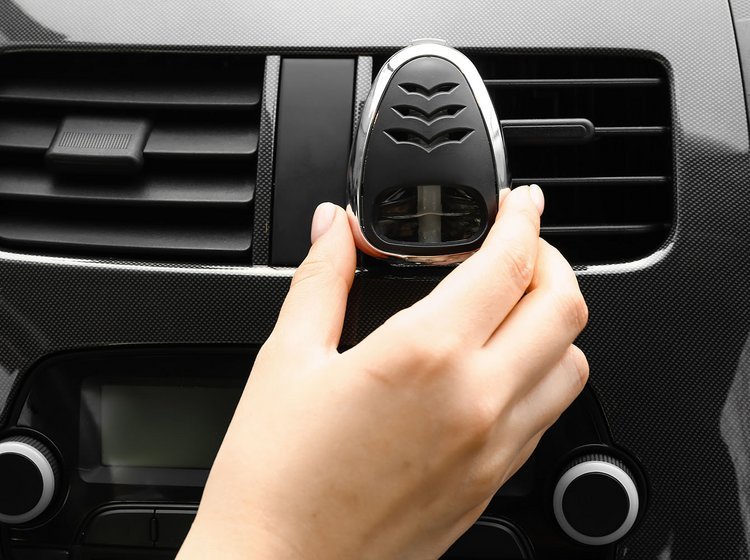 Luftfrisker med parfume placeres i en af bilens ventilationskanaler. 