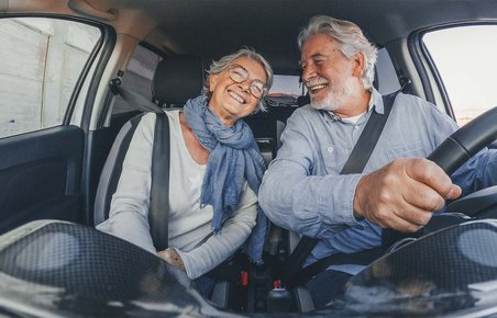 Ældre mandlig bilist med ældre kvindelig passager