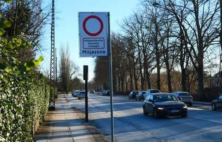 Miljøzoneskilt på vej med bil
